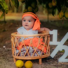 This little one is curious about the mangoes hanging from the tree above him. Outdoor sessions are great for capturing natural curiosity.