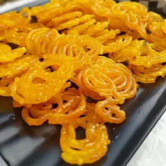 Crispy, hot jalebis served at a corporate Holi party. No festive celebration is complete without traditional sweets, and we make sure to include these favorites in our menus.