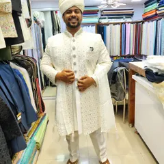 An all-white ensemble for the groom who loves elegance. This client looks sharp and ready for his big day in his custom sherwani and safa.