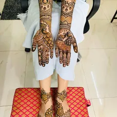A full bridal set with matching designs for hands and feet. The hands feature peacock motifs, while the feet have a simpler, elegant pattern, creating a balanced look.