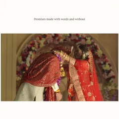 The Varmala or Jaimala exchange is a beautiful and significant ritual. This shot captures the moment of the promise, framed by a stunning floral arch, symbolizing the start of a new journey together.