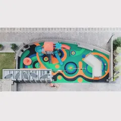 An aerial detail of the playground's custom EPDM rubber flooring, where abstract patterns create a visual landscape for imaginative play.