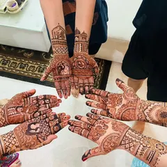 A beautiful group shot of the bride and her squad, each with their own unique yet coordinated mehendi design.