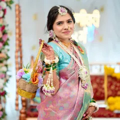 Ready for her baby shower ceremony. The complete look, with the traditional saree, floral accessories, and radiant makeup, comes together to create a picture of pure grace and joy.