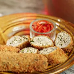 A close-up of my Chicken Swiss Rolls, showing the delicious minced chicken and herb filling inside the crispy breaded exterior.