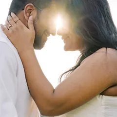 This is the magic of golden hour. The sun creates a beautiful flare as the couple connects, forehead to forehead. It's an intimate, powerful silhouette that focuses purely on their love.