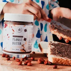 A lifestyle product shot showing the peanut butter being spread on bread. Including my son's hands adds a relatable, family-friendly touch that helps customers connect with the product on a personal level.