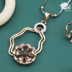 The pendant of the Eclipse Glow necklace, showcasing its intricate construction. Baguette-cut diamonds radiate from a black diamond core, suspended within an undulating rose gold form for a truly unique design.