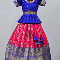 A mannequin view of the blue and pink lehenga, showcasing the detailed maggam work on the peplum top.