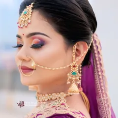 A close up of a classic bridal look, featuring a colorful smokey eye and a chic updo. This style is perfect for the modern bride who wants a touch of tradition with a whole lot of glam.