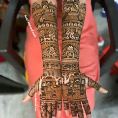 A perfect example of my full-arm bridal mehndi in a traditional Rajasthani style. This symmetrical design features classic motifs like the doli (palanquin) and elephants, covering the arms from fingertips to elbow.