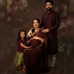 A fine art maternity portrait celebrating a growing family. We created this traditional, painterly look in our studio, complete with elegant attire and a classic backdrop to honor this special time before the new baby arrives.