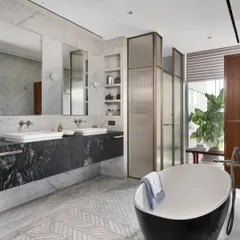 The master bathroom of the Worli Duplex showcases our approach to timeless luxury through a palette of black and white marble. We used a combination of white Carrara and Bianco Nero marble, with detailed mosaic flooring, to create a space that is both classic and contemporary.