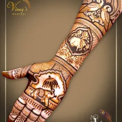 A single-hand view of the royal elephant design, showing the intricate details of the elephant's adornments and the peacock motifs on the arm.