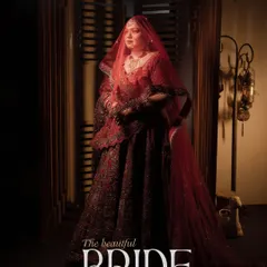 A classic and elegant portrait titled "The beautiful BRIDE." The soft lighting and the bride's regal pose under her red veil create a timeless and sophisticated image that highlights her grace.