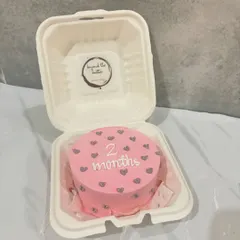 A cute pink bento cake to celebrate a baby's two-month milestone. It's decorated with little grey hearts and the message "2 months."