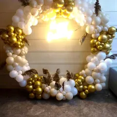 A different perspective on our elegant white and gold balloon ring. This photo highlights the beautiful combination of chrome gold and matte white balloons, accented with dried pampas for a boho-chic vibe.