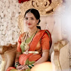 A regal portrait of a mom-to-be at her baby shower. The makeup is classic and elegant, with a soft gold eyeshadow and a warm lip color to complement her saree.
