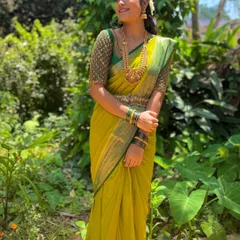 Another pose showing the full look of the lime green saree and the intricately beaded green blouse.