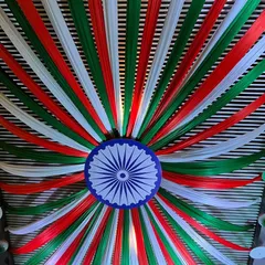 A stunning ceiling decoration for a national event. I used saffron, white, and green fabric strips to create a massive canopy radiating from a central Ashoka Chakra.