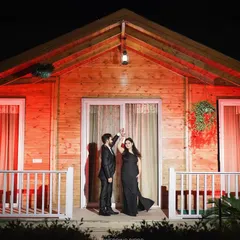A romantic dance on the porch of a warmly lit cabin at night. This shot is part of the same cinematic pre-wedding series, showing how we can create a variety of beautiful moments within one creative concept.
