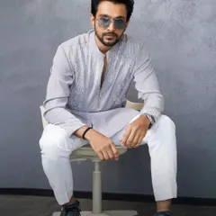 When style meets smolder. Pratik Gandhi serves a look that can’t be ignored in this full-length shot of my grey embroidered kurta set, paired with crisp white trousers.