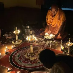 I am performing a puja, a ritual of worship, surrounded by lamps and offerings. These ceremonies are a vital part of ashram life, cultivating devotion and focus.