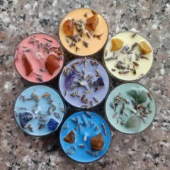 This is my popular 7 Chakra healing candle set, shown here as tealights. Each candle is colored and infused with a specific crystal and botanical blend, like lavender, to correspond with each chakra for balancing rituals.