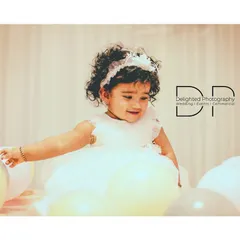 These quiet, in-between moments are just as precious. Here, she explores the balloons that are part of her first birthday party setup.