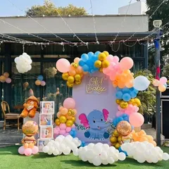 This outdoor baby shower setup was a lot of fun. I used a cute elephant theme with a custom backdrop, a colorful balloon arch, and 'BABY' blocks to welcome the little one.