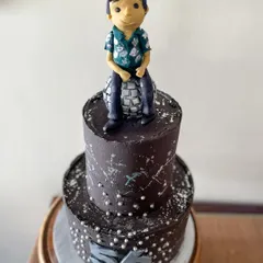 A closer look at the disco cake, showing the custom topper and silver details.