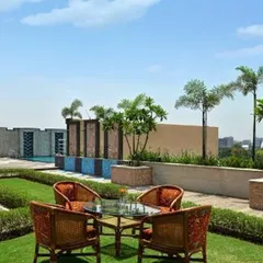 A rooftop can become a functional and beautiful lawn with a view. This project demonstrates our ability to create lush, green turf areas in urban high-rise environments, complete with curated trees and shrubs in stone planters, offering a classic garden experience elevated above the city.