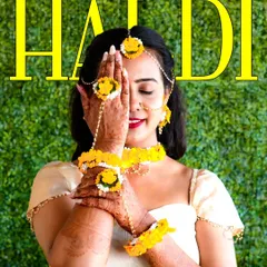 A beautiful and artistic portrait of the bride during her Haldi ceremony. The floral jewelry and henna-covered hands are key details I love to highlight.