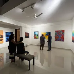 Guests enjoying an evening at the gallery, taking their time to appreciate the collection. We are open until 9 PM, so you can visit after work for a few meaningful hours surrounded by art.