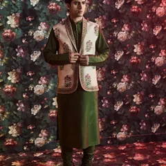 This ensemble pairs a forest green raw silk kurta with a classic Nehru jacket featuring authentic Jaipuri hand block prints, showcasing our dedication to heritage crafts.
