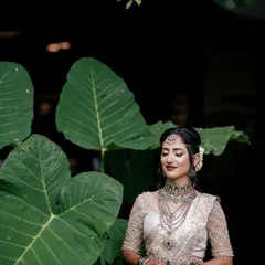 The bride looks serene and beautiful in this shot. The detailed mehendi on her hands is a key part of her traditional attire, perfectly matching the elegance of her look.