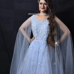 A full-length view of the elegant powder blue gown. The flowing fabric and delicate details make it a dream outfit for any grand event.
