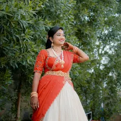 Radiant and glowing! My cherished client Harshitha dazzles on her engagement day in this custom-made red and ivory half saree that I crafted for her in under a week. She looks absolutely stunning.