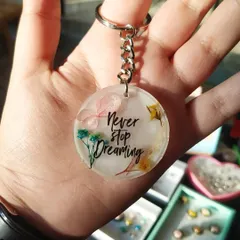 A floral keychain with the quote "Never stop dreaming." These make for wonderful motivational gifts, and I can customize them with any quote you like.