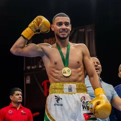 Victory. Mohammad Issa celebrating with his medal after a successful bout in the WBC Boxing Grand Prix, a major step on the international stage.
