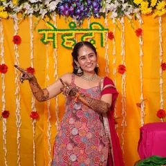 For Surbhi's intimate 'ghar wali mehendi', she wore a beautiful red sharara suit. We kept the look traditional and elegant with a light, intricately detailed necklace, jhumkas, and a maangtikka.