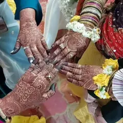 A beautiful, candid shot from a party showing the amazing stain results on multiple hands. This is the joy of a mehndi celebration, captured in one photo.