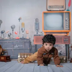Here is a full view of my 'Chhota RJ' or retro radio jockey theme. The set is filled with vintage props like an old television, classic microphones, and a guitar to create a unique, nostalgic vibe for your baby's photoshoot.