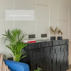 We believe storage should be both smart and stylish. This custom black cabinet features a playful, geometric pattern on its shutters, turning a functional piece into a sculptural element in the room.