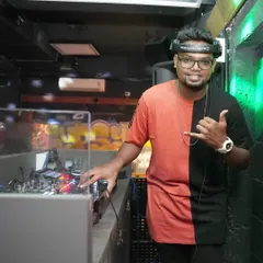 At the console with my headphones on, fully immersed in the music. This is my happy place, creating a great vibe for the night.