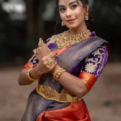 The intricate embroidery on the purple blouse adds another layer of artistry to this stunning ensemble.