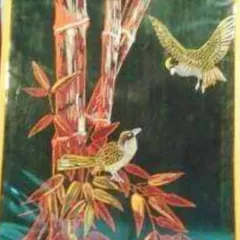 A beautiful and intricate painting made from slivers of bamboo, created by an artisan in Imphal. This unique piece of art, depicting birds on bamboo stalks, showcases the incredible versatility of bamboo as an artistic medium.