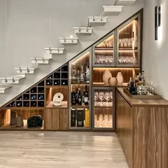 I love transforming unused areas into functional, beautiful features. Here, I designed a custom bar and crockery unit to fit perfectly under a staircase, featuring a dedicated wine rack, glass-front cabinets with internal lighting, and a serving counter.