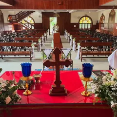 A view from the altar of a church decorated for a wedding. I provide simple and elegant decorations for the pews and the altar to create a serene and beautiful environment.