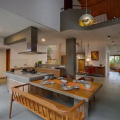 The open-plan kitchen and dining area is the heart of this home. We designed the pantry to extend seamlessly into a dining table, creating a central hub for family activity that overlooks both the garden and an internal courtyard.